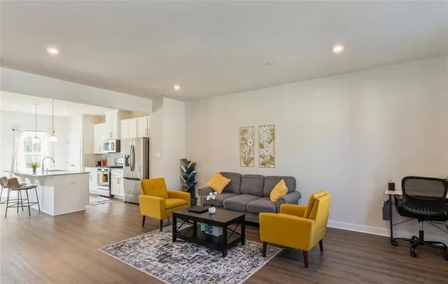 a living room with furniture wooden floor and a table