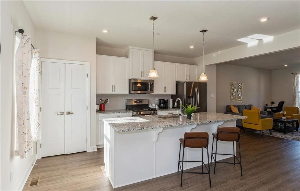 6702 Sycamore Way Gibsonia, PA 15044 - Photo 9 of 29 a view of a kitchen with kitchen island stainless steel appliances refrigerator stove dining table and chairs