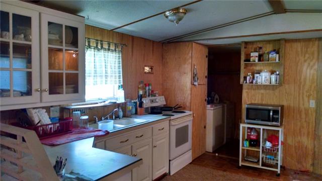 8255 Pinewood Road Nunnelly, TN 37137 - Photo 8 of 13 Updated Kitchen with pantry, stove remains, wood floor, and lots of cabinets