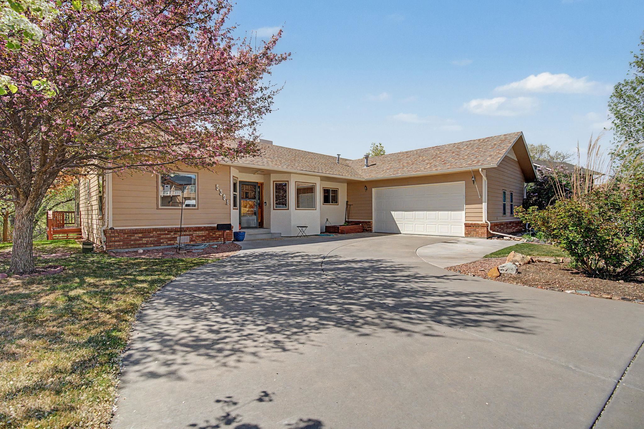 539 1/2 Ridgestone Court Grand Junction, CO 81507 - Photo 1 of 31 a front view of a house with a yard and trees