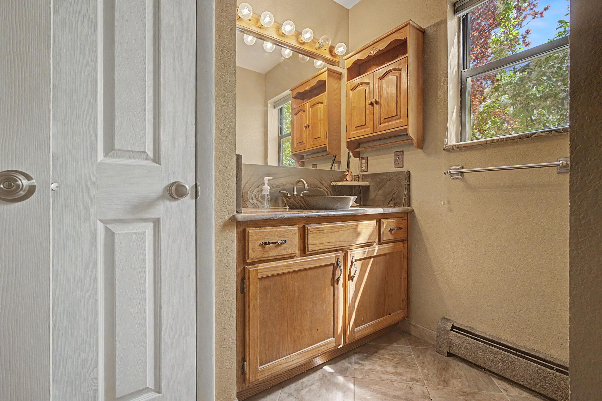 539 1/2 Ridgestone Court Grand Junction, CO 81507 - Photo 15 of 31 a bathroom with a granite countertop sink and a mirror