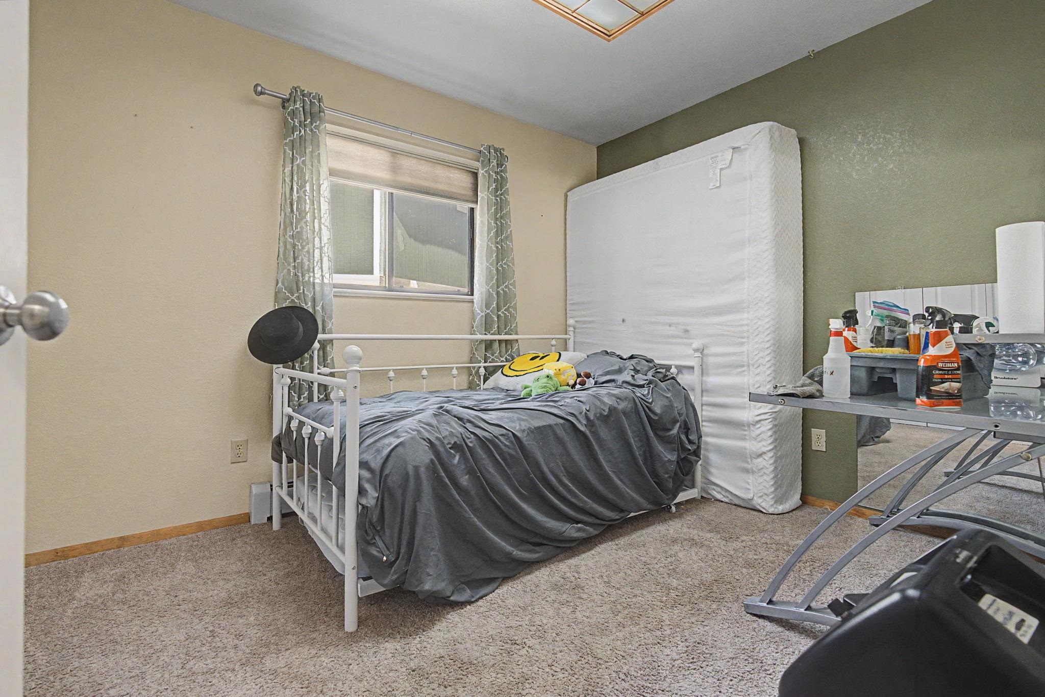 539 1/2 Ridgestone Court Grand Junction, CO 81507 - Photo 25 of 31 a bedroom with a bed and window