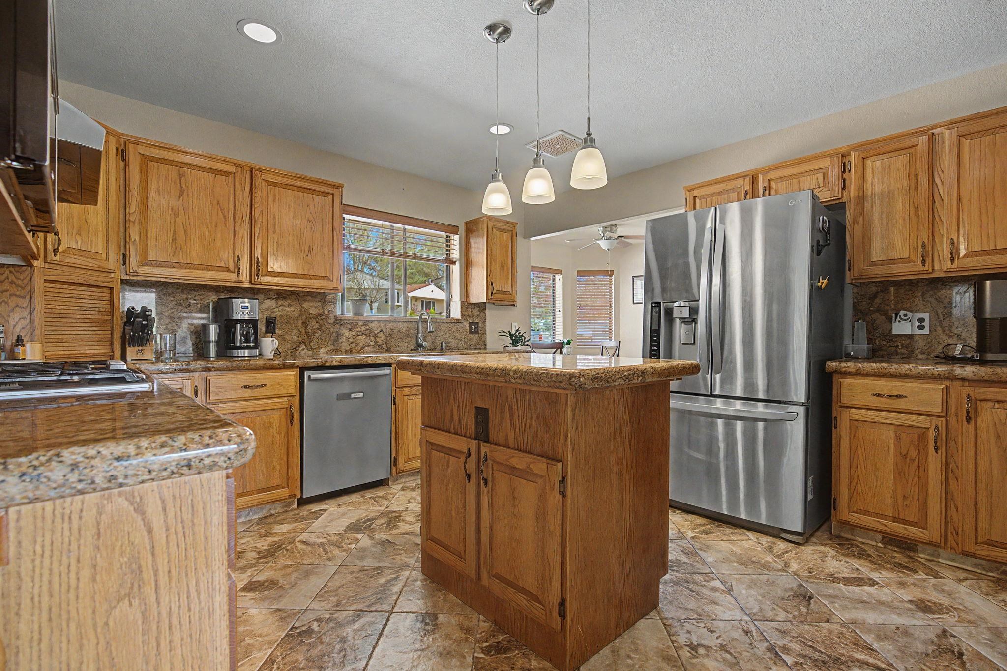 539 1/2 Ridgestone Court Grand Junction, CO 81507 - Photo 5 of 31 a kitchen with refrigerator cabinets and a sink