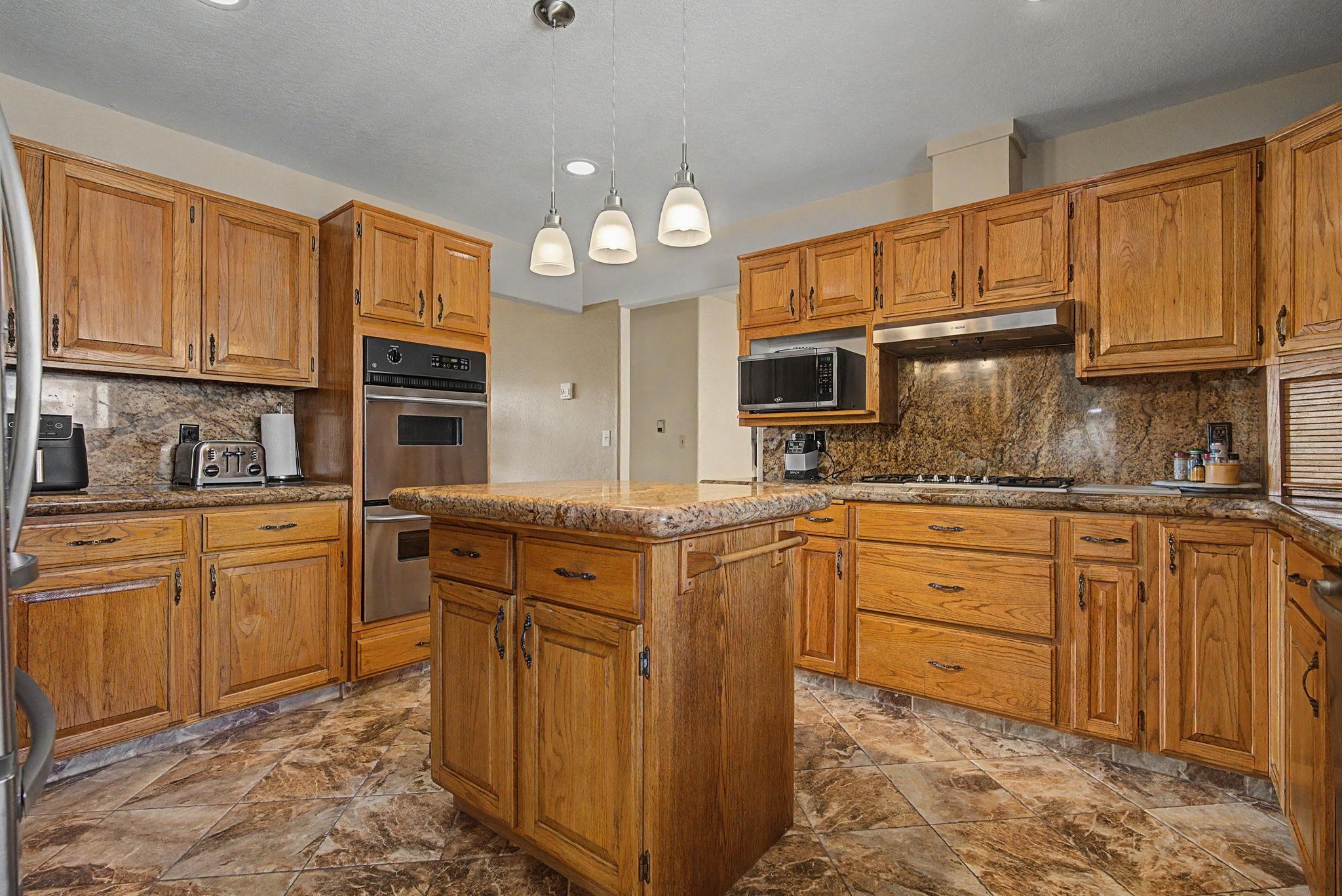 539 1/2 Ridgestone Court Grand Junction, CO 81507 - Photo 6 of 31 a kitchen with granite countertop a sink stainless steel appliances and cabinets
