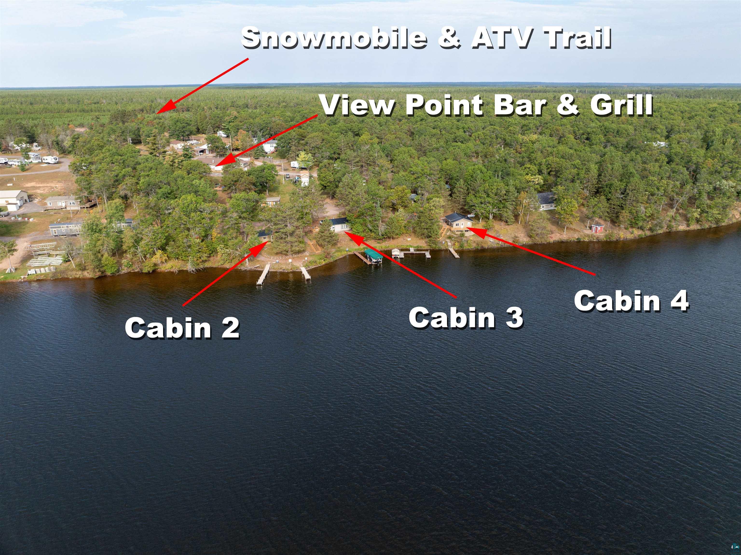 6833 View Point Lodge Road, Unit 13 Gordon, WI 54838 - Photo 5 of 32 Bird's eye view of a forest and a nearby body of water