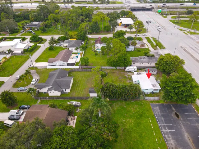 an aerial view of house with yard swimming pool and outdoor seating