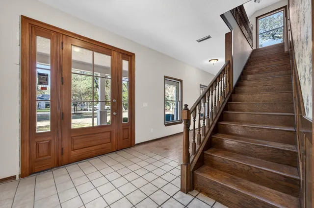 a view of a livingroom with wooden floor and windows
