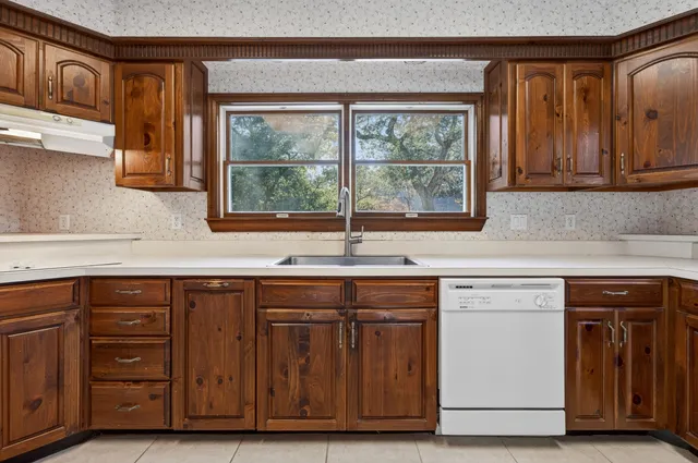 a spacious bathroom with a granite countertop sink mirror and a
