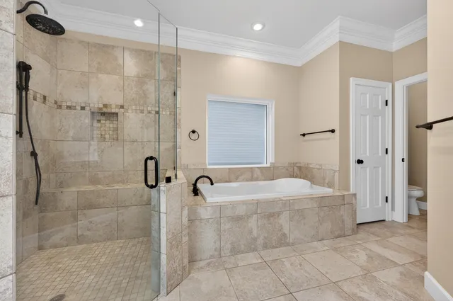 an empty room with windows and ceiling fan