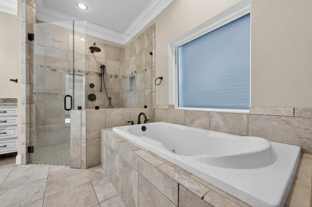 a front view of a house with garden and patio