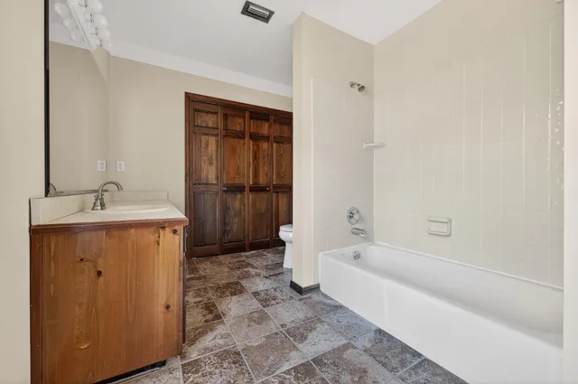 a view of a backyard of a house with a large tree