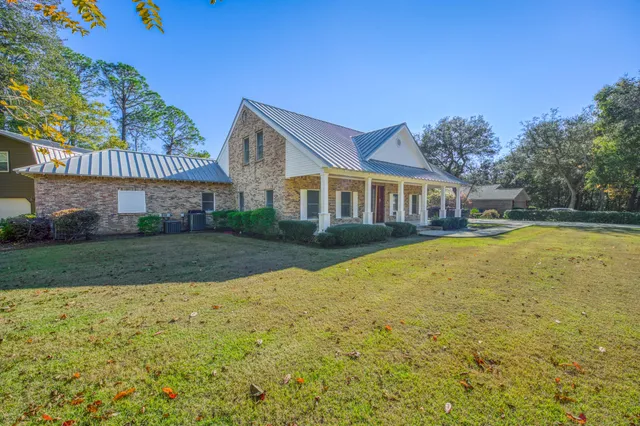 a view of a white building with swimming pool in front of it