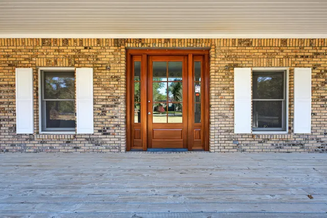 a view of an empty room with a window and a ceiling fan
