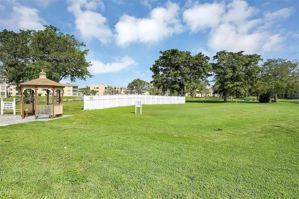 a view of yard with swimming pool and green space