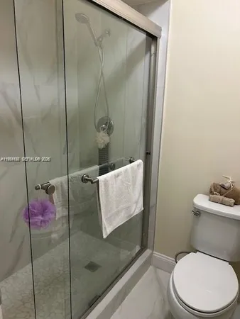 a bathroom with a toilet and a shower
