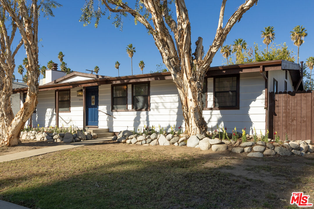 a view of a house with a tree in front