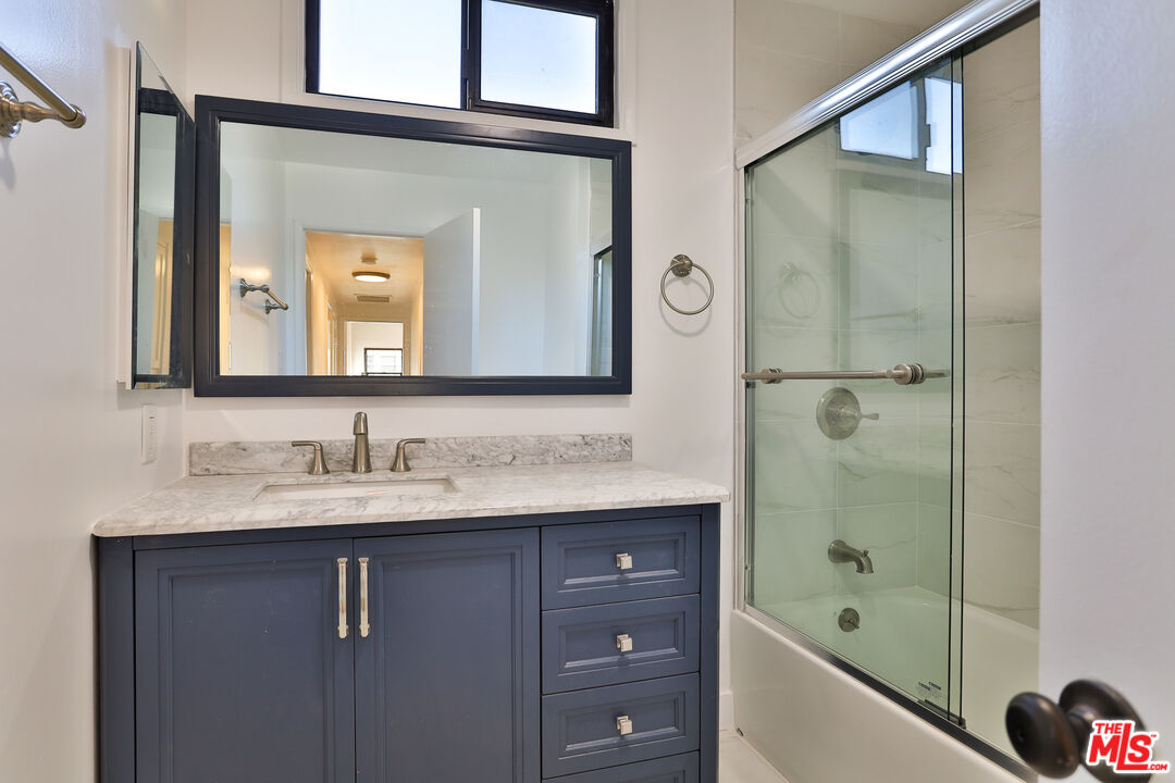 20341 Enadia Way Winnetka, CA 91306 - Photo 13 of 23 a bathroom with a bathtub sink vanity and mirror