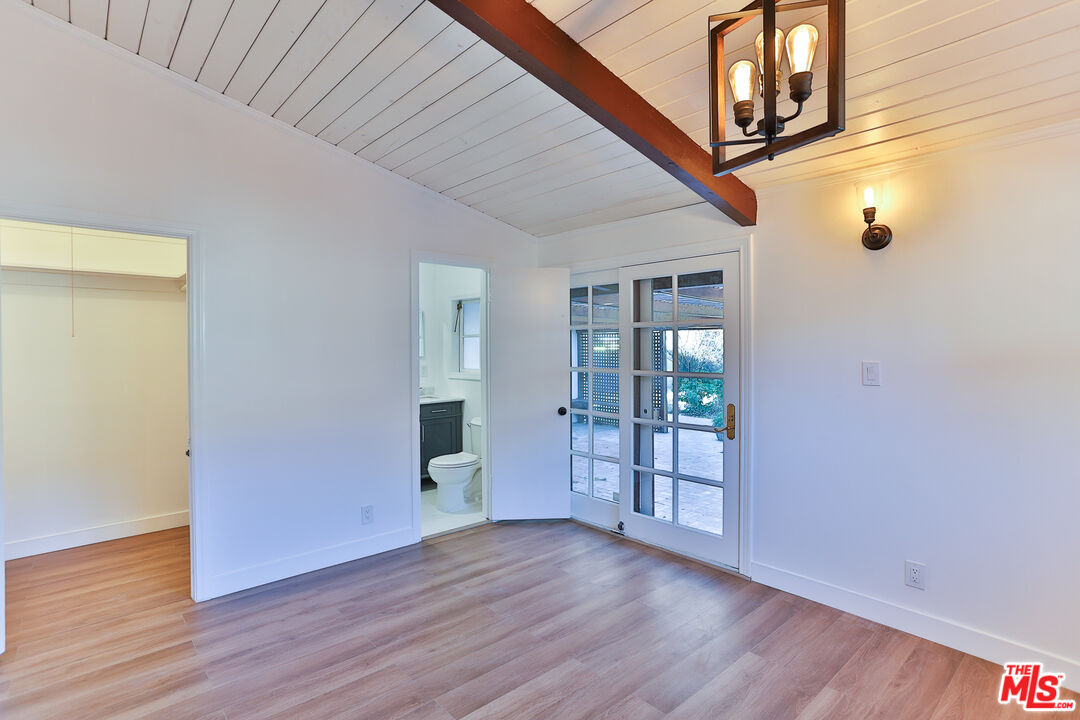 20341 Enadia Way Winnetka, CA 91306 - Photo 16 of 23 a view of an empty room with wooden floor and a window