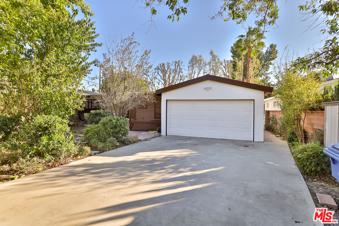 20341 Enadia Way Winnetka, CA 91306 - Photo 23 of 23 a front view of a house with a yard and garage