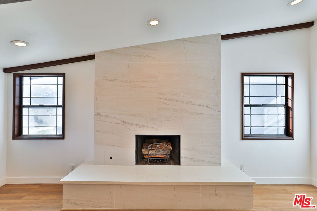 20341 Enadia Way Winnetka, CA 91306 - Photo 4 of 23 a view of an empty room with a window and wooden floor
