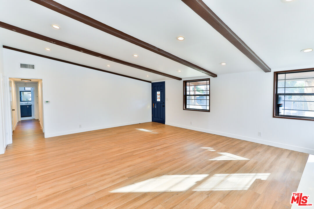 20341 Enadia Way Winnetka, CA 91306 - Photo 5 of 23 a view of an empty room with wooden floor and a window
