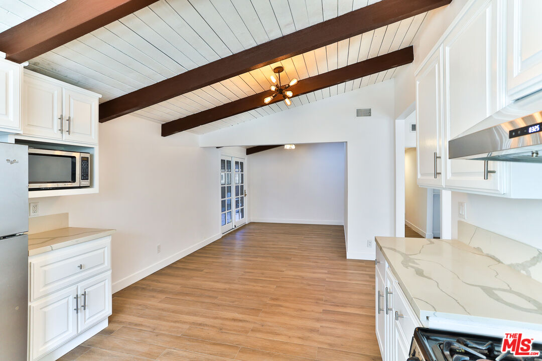 20341 Enadia Way Winnetka, CA 91306 - Photo 7 of 23 a view of a kitchen cabinets and wooden floor