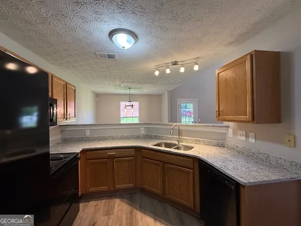 a kitchen with a sink and a stove