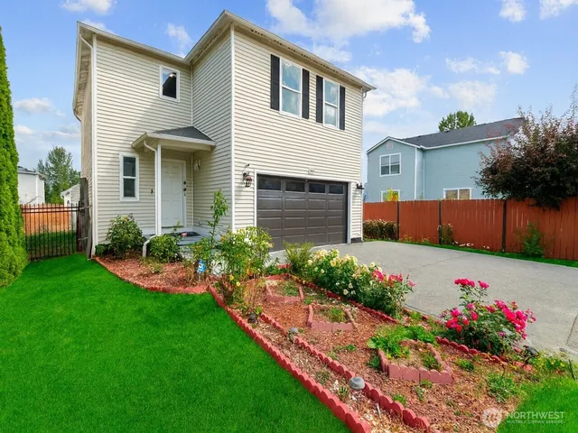 a front view of house with a garden