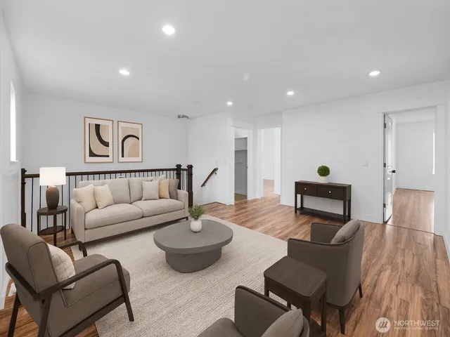 a living room with furniture and wooden floor