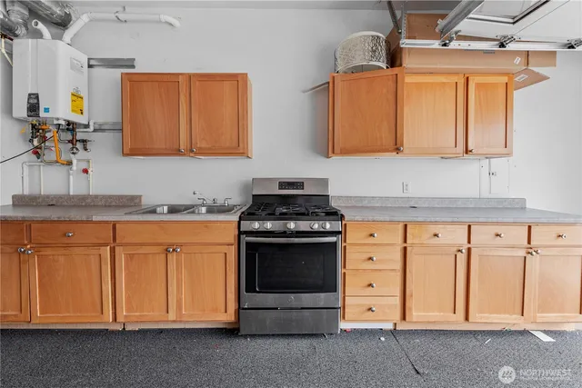 a kitchen with stainless steel appliances granite countertop a stove and a sink
