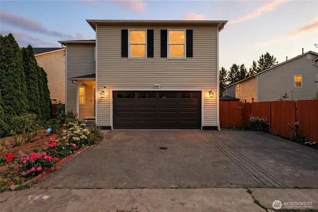 a front view of a house with a yard and garage