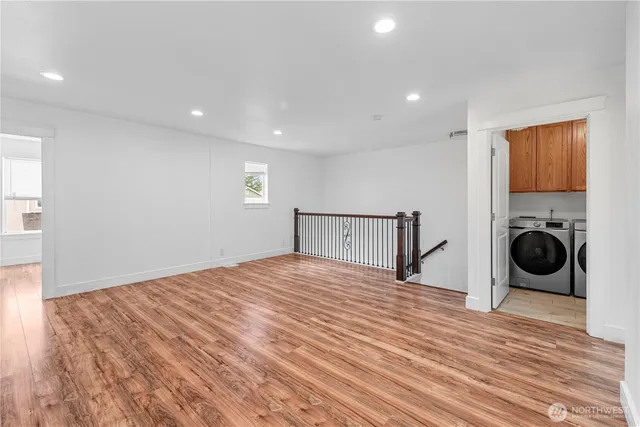 a view of a livingroom with a fireplace and wooden floor
