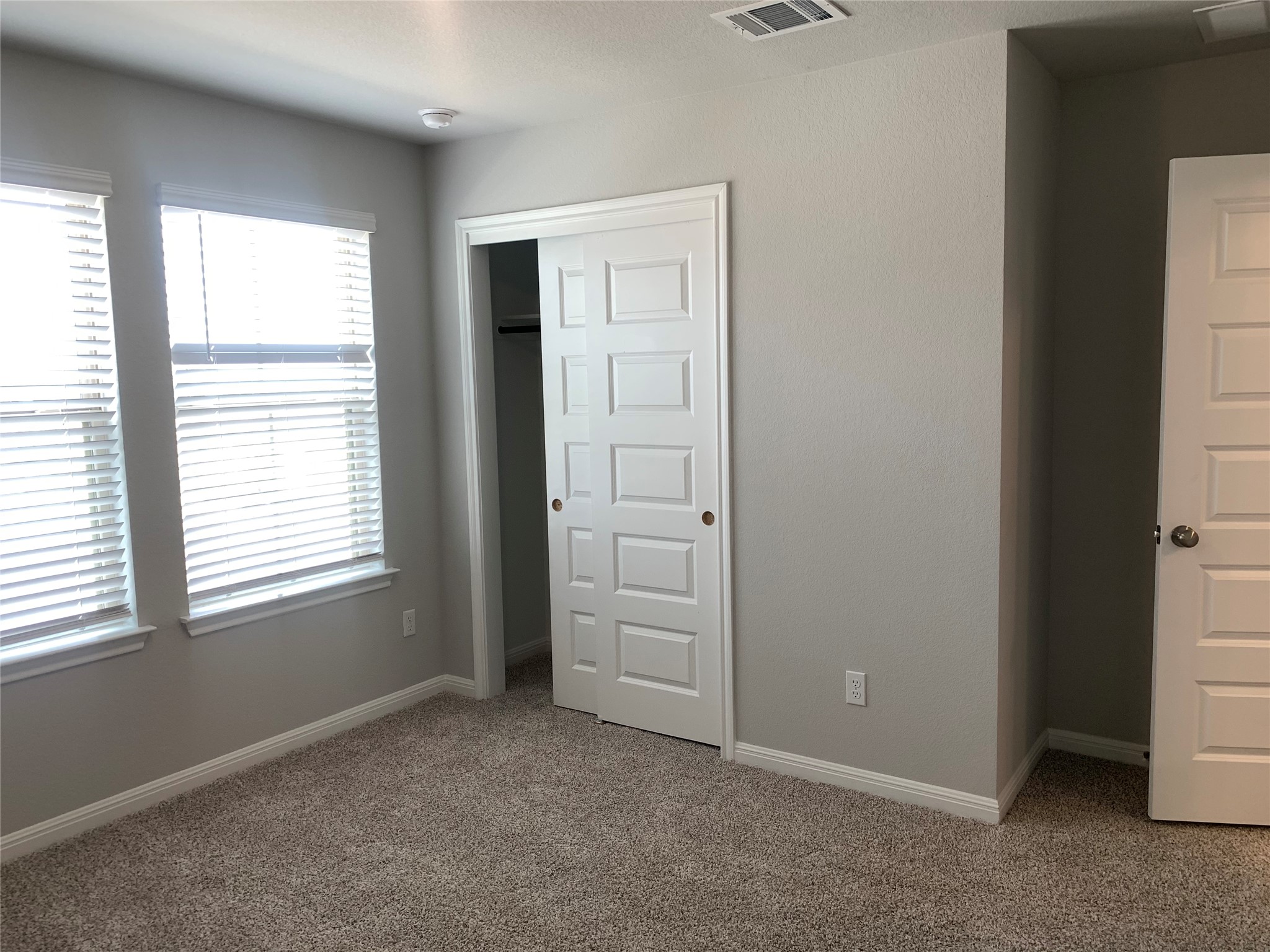 2948 Sage Ranch Drive Leander, TX 78641 - Photo 24 of 28 Ample natural light illuminates a comfortable bedroom with a generous closet space.