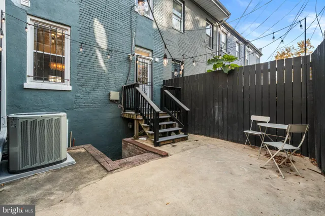 a view of a backyard with chairs and a grill