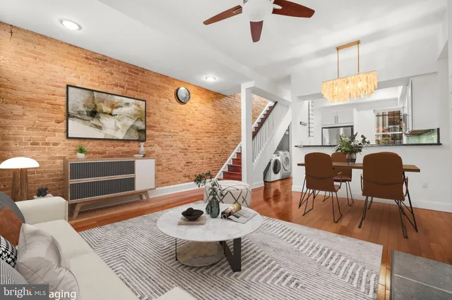 a living room with furniture a chandelier and a dining table