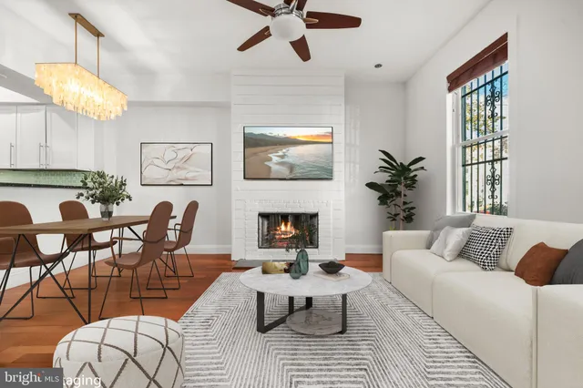 a living room with furniture fireplace and window