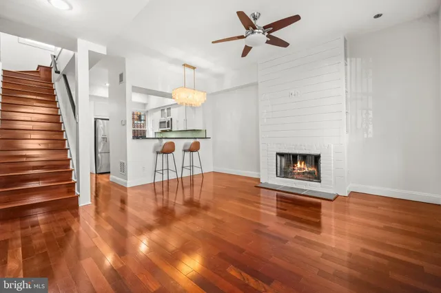 a view of empty room with wooden floor and fireplace