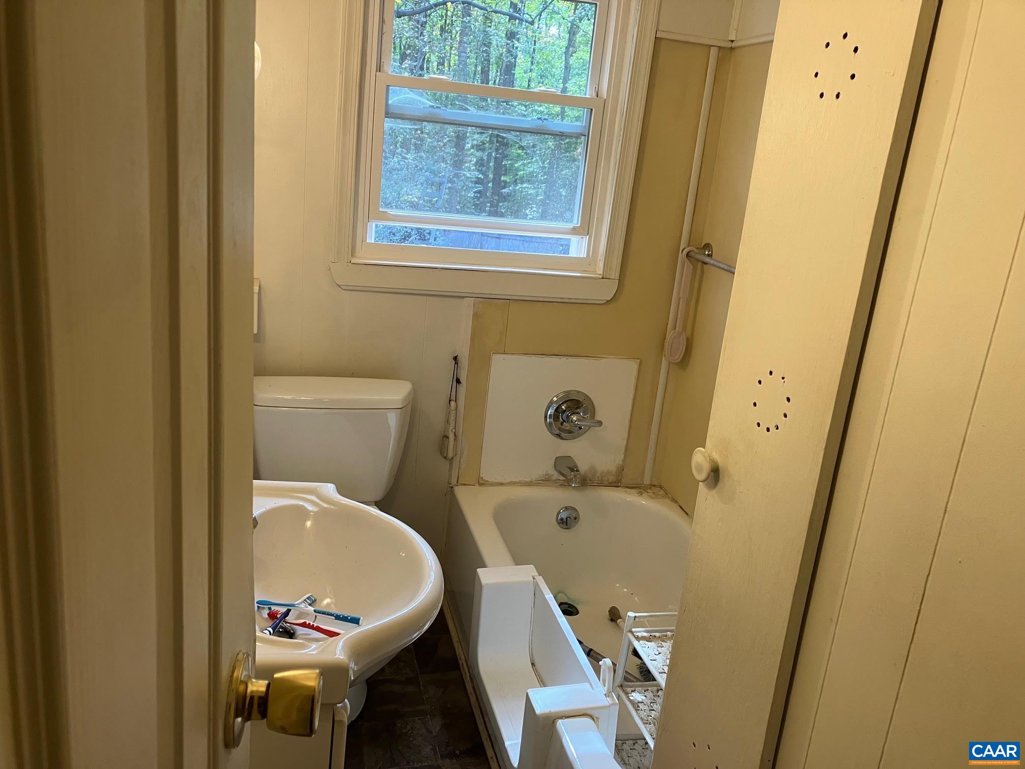 8203 Chestnut Grove Road Esmont, VA 22937 - Photo 11 of 13 a bathroom with a sink and a tub