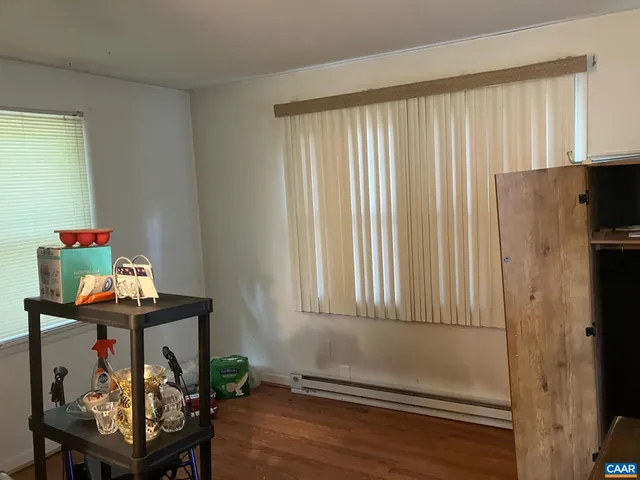 a view of a room with furniture and wooden floor