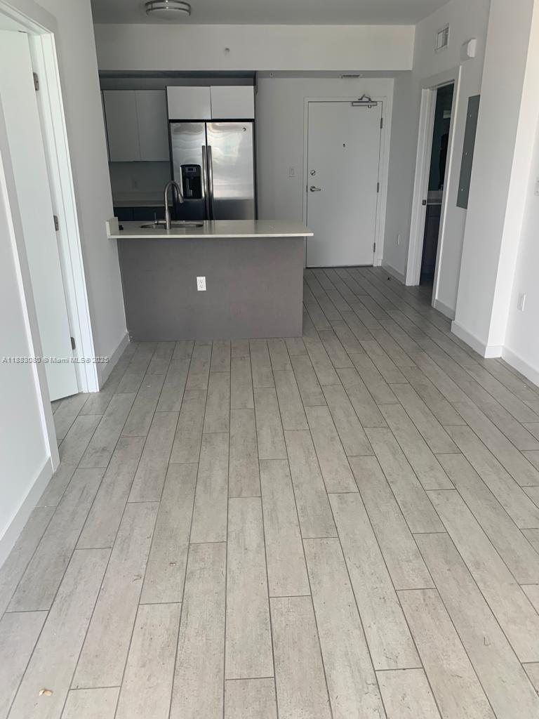 321 Northeast 26th Street, Unit 710 Miami, FL 33137 - Photo 15 of 21 a view of kitchen with a sink wooden floor and staircase