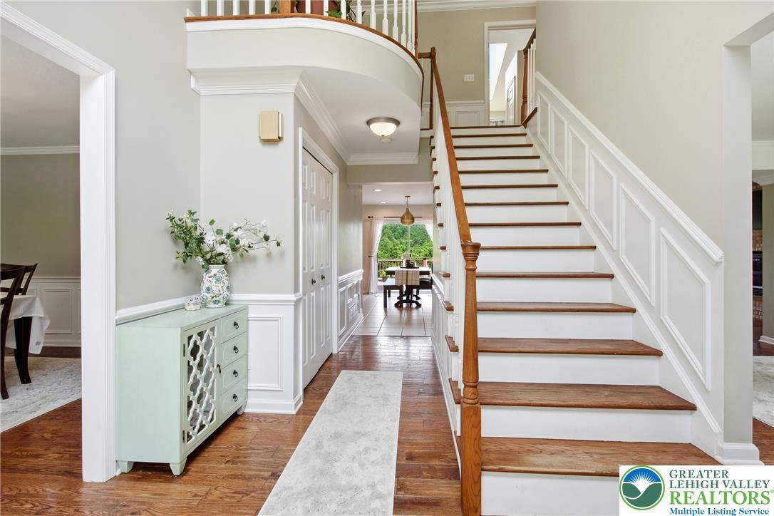 115 West Butternut Road Hellertown, PA 18055 - Photo 7 of 97 A grand entryway features a graceful curved staircase, leading to open-concept living spaces.