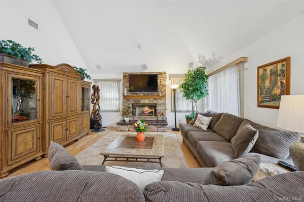 a living room with furniture fireplace and flat screen tv