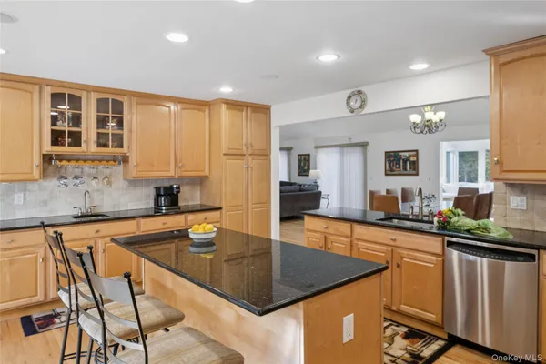 a kitchen with stainless steel appliances granite countertop a sink counter space and cabinets