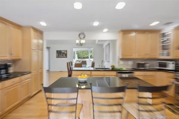 a kitchen with granite countertop a sink and cabinets