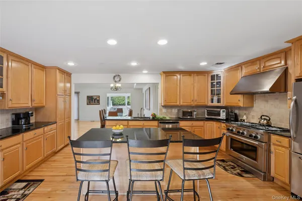 a kitchen with a table chairs stove and cabinets