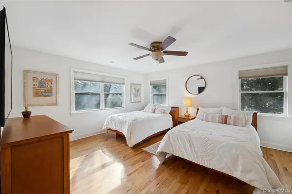 a bedroom with two beds and a large window