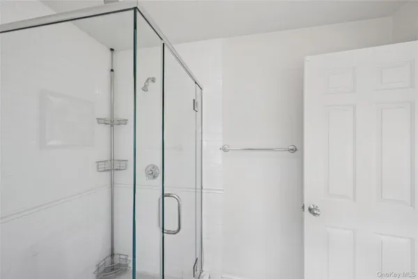 a bathroom with a glass shower door