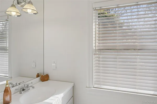 a bathroom with a sink and a window