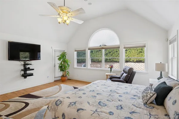 a bedroom with a bed and a large window