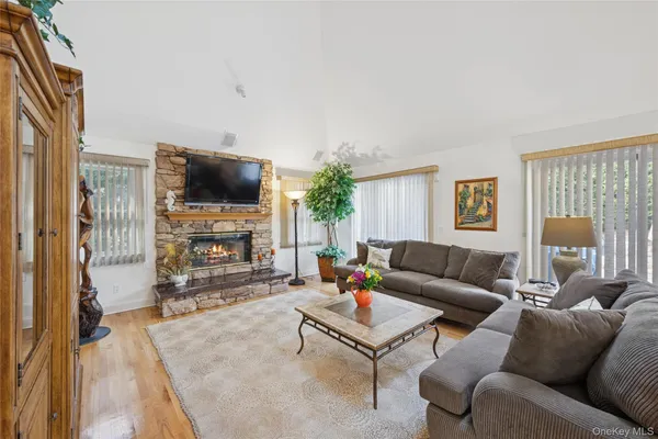 a living room with furniture a fireplace and a flat screen tv